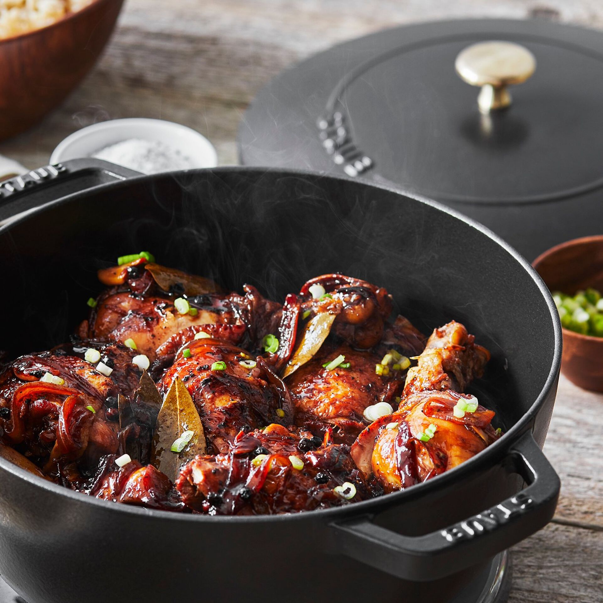 Staub matte black French oven with chicken inside.