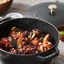 Staub matte black French oven with chicken inside. preview
