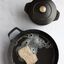Staub matte black cast iron with soap and sponge. preview