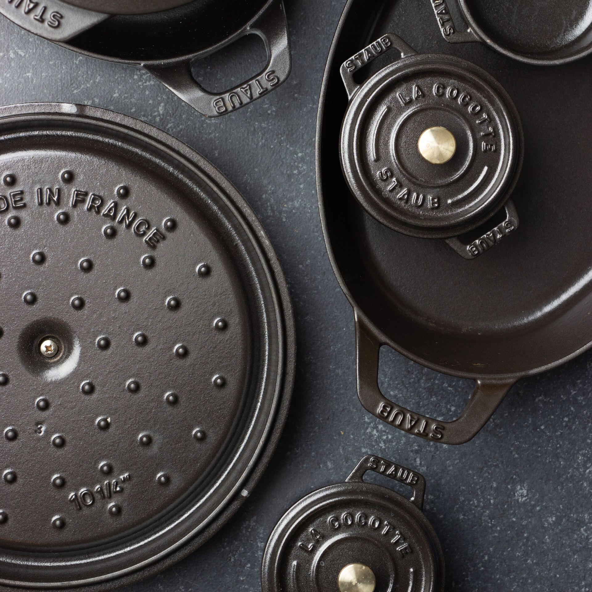 Underside of Staub matte black dutch oven lids with textured interior.