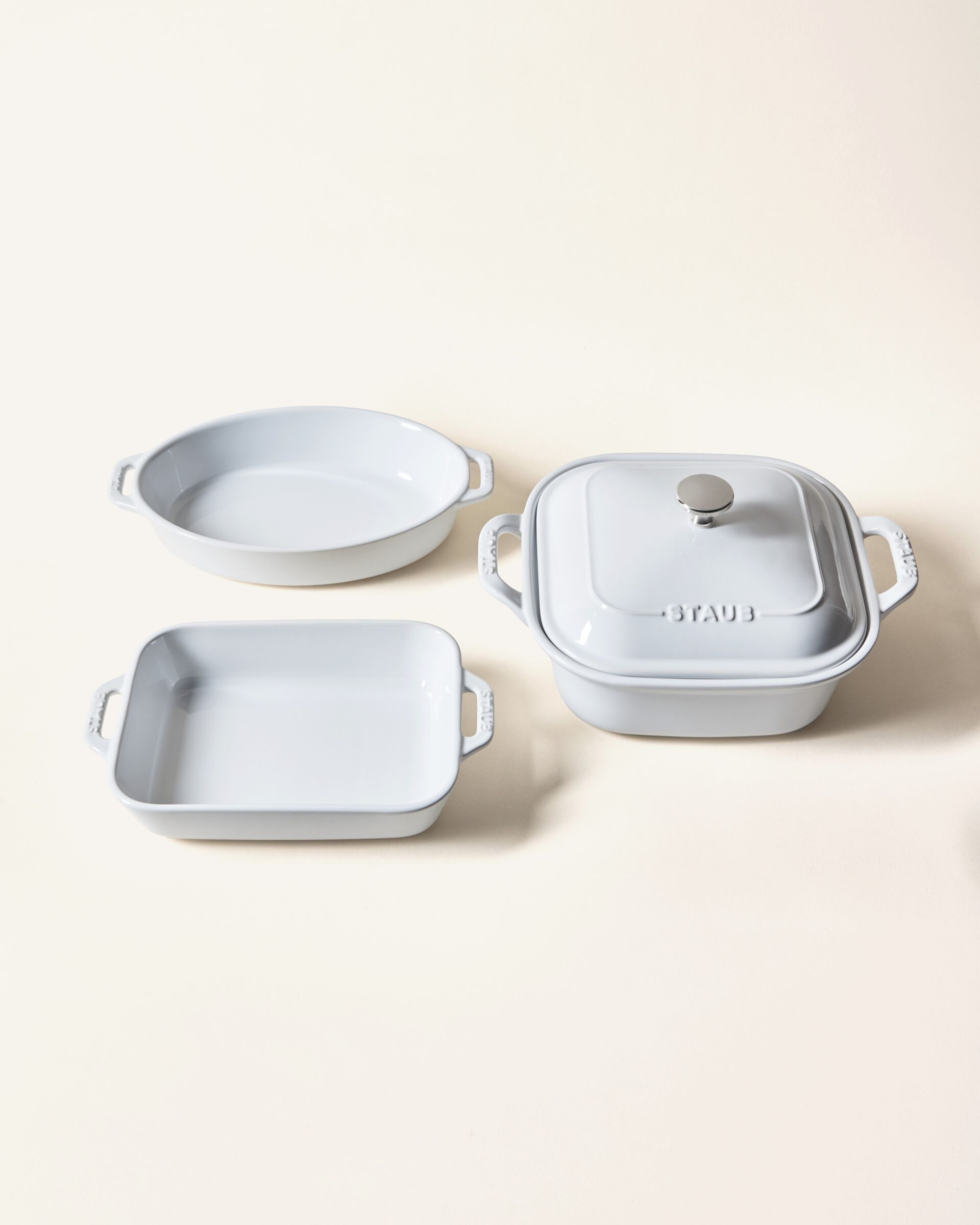 Two nesting STAUB high-quality ceramic baking dishes next to one ceramic pie dish
